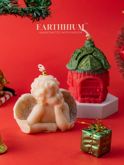 An angel and a house candle set, perfect for creating a serene and magical Christmas display.