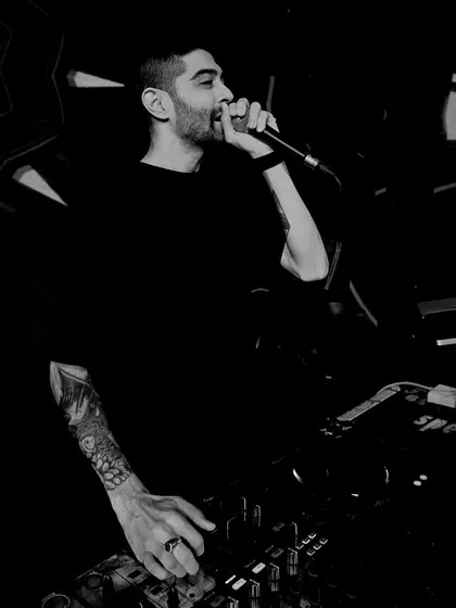 It's not just about playing music; it's about connecting with the crowd. Here I am on the microphone, hyping everyone up and making sure the energy never drops. This is a key part of my live performance style.