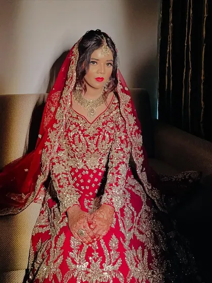 A dramatic shot of the bride, with shadows highlighting the contours of her face and the richness of her outfit.