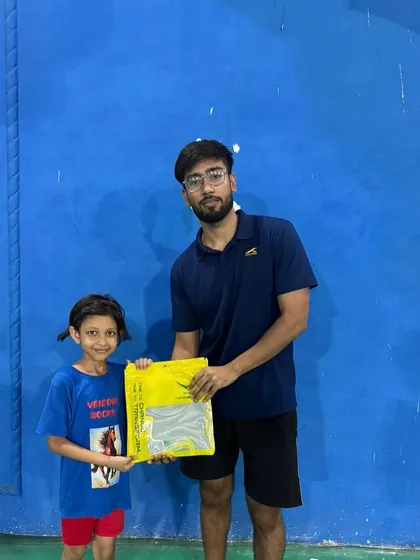Even our youngest winners are recognized for their achievements. Here, an assistant coach presents a prize to our budding U9 champion.
