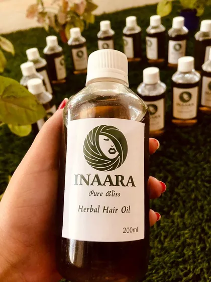 This is my other bestseller, Pure Bliss Herbal Hair Oil. It's formulated to significantly reduce hair fall, combat frizz, and improve your hair's texture and volume, leaving it smooth, shiny, and hydrated.