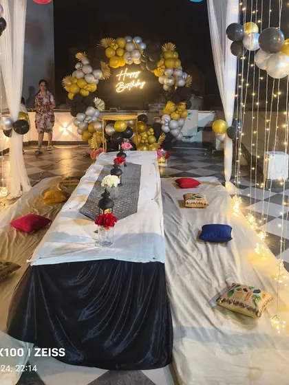 A wide shot of the terrace party setup, showing how the canopy and lighting create a magical and inviting space for an evening celebration.