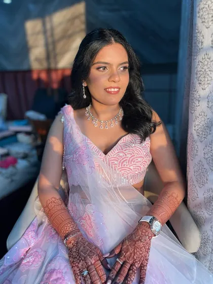 A lovely pink and white lehenga paired with a soft, rosy makeup look for an engagement ceremony. The golden hour light makes her glow.