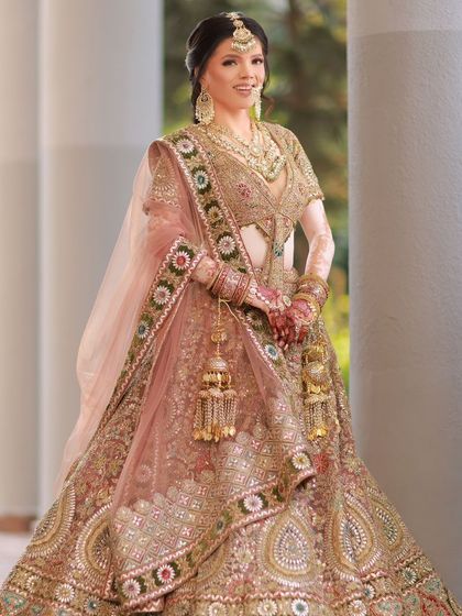A full-length shot showing her complete bridal look. She looks absolutely breathtaking and confident in her stunning lehenga.