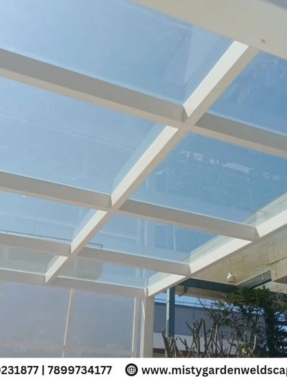 Looking up through the toughened glass roof, you can see the clear blue sky. This design offers protection from rain while making you feel connected to the outdoors.