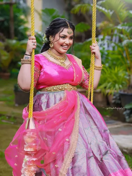 A playful shot of the bride on a swing in a garden. The movement and her joyful smile capture a moment of pure happiness.