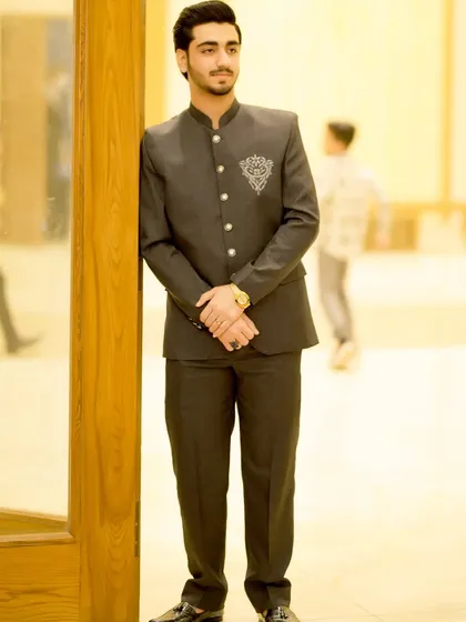 A full-length view of the groom's stylish reception outfit. The Jodhpuri suit is a great alternative to a Western-style suit.