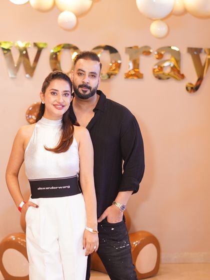 The proud parents posing at their son's third birthday party. We handle all the details so parents can relax and enjoy the celebration.