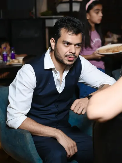 A candid shot of a guest during a conversation at a party. I focus on capturing the natural, unposed moments of the event.