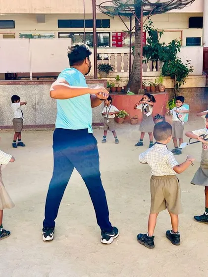 A typical warm-up session in the schoolyard, where I lead the children in simple torso twists. We always start with exercises like this to get the blood flowing and prepare for more active games.