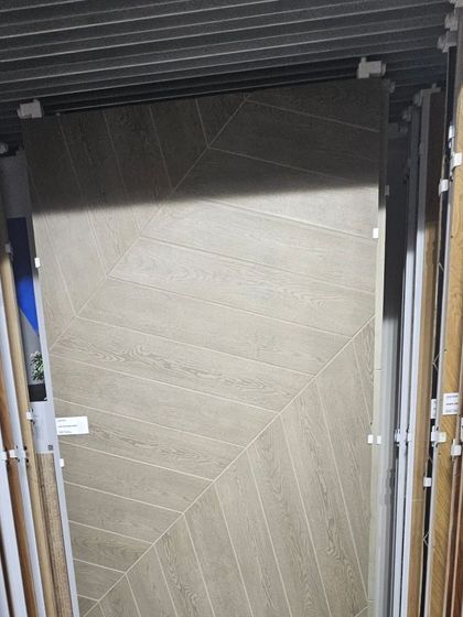 A wood-look tile in a chevron pattern. This gives you the classic, elegant appearance of a wooden floor but is ideal for high-traffic or wet areas like kitchens and bathrooms.