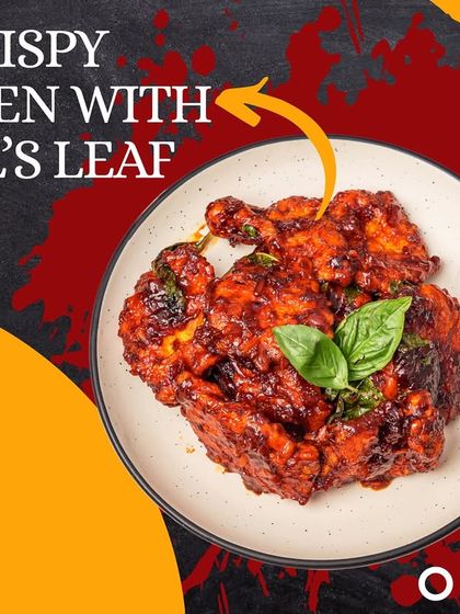 This is our Crispy Chicken with Basil's Leaf. The chicken is fried until extra crispy and then tossed in a spicy sauce with fresh basil leaves for a fragrant kick.