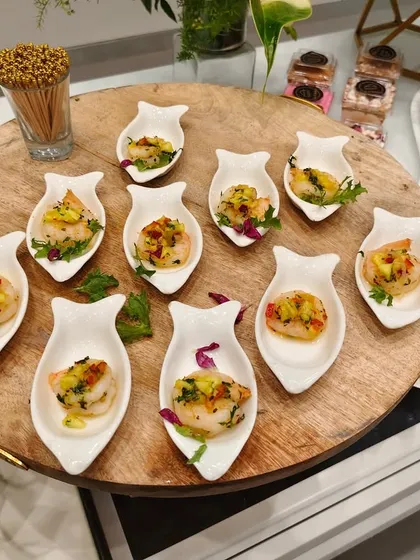 Tiny plates, endless flavor. We believe in serving elegance one bite at a time, as seen with these beautifully arranged prawn appetizers.