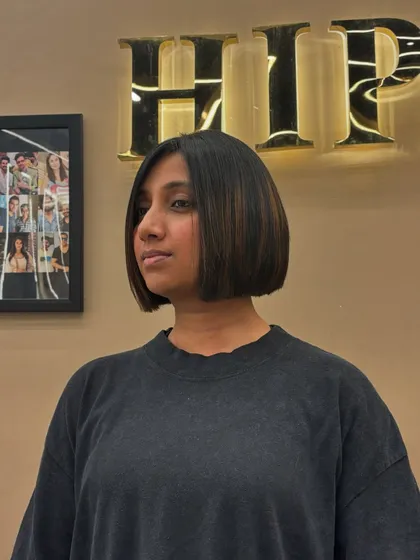 This is a classic, sharp bob haircut. It's a timeless style that is both chic and modern, defined by its clean lines and sleek finish. I added subtle highlights to give it dimension.