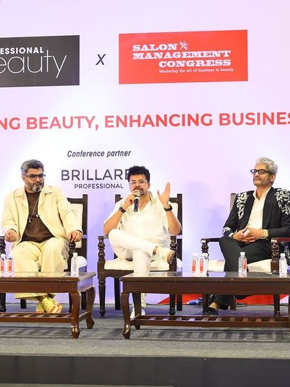 A wide angle of the panel discussion, showing the full group of industry leaders sharing their insights with the audience.