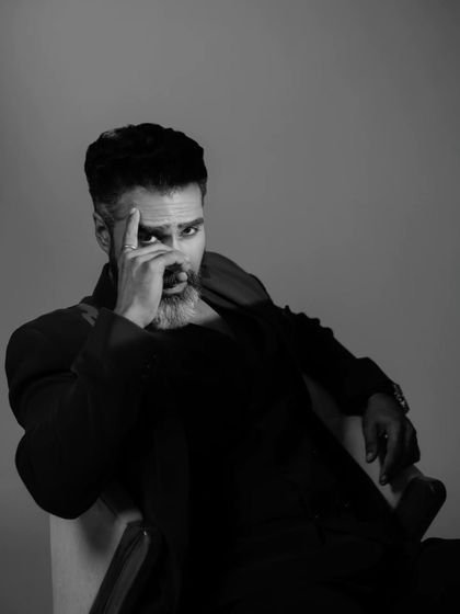 In this shot, we explored a more contemplative pose. The composition is intentionally tight, focusing on the subject's eyes and the subtle emotion conveyed through his expression in this moody black and white frame.