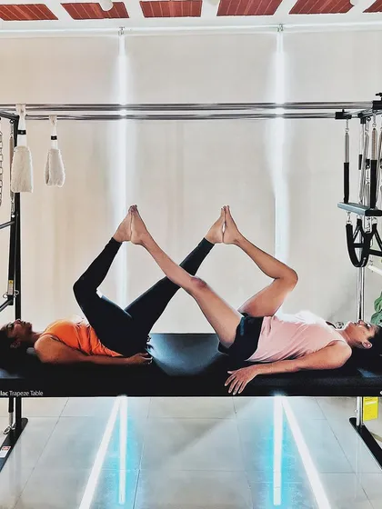 The Pilates community cultivates harmony. This synchronized leg press on the Cadillac shows how we work together to find balance.