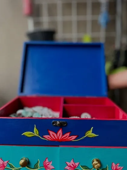 Another view of the hand-painted jewelry box, showing its vibrant colors and functional design.