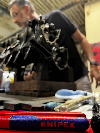 A focused shot of the R6 engine block during the rebuild process, with me in the background overseeing the work.