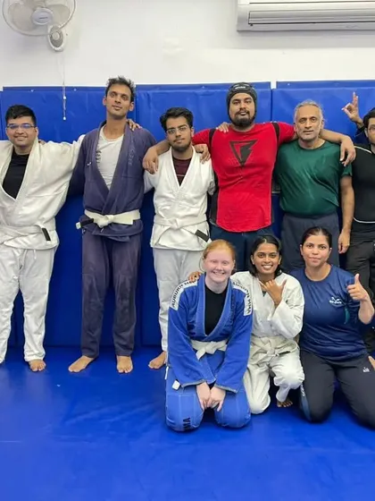 A mix of kneeling and standing members, showing the relaxed and respectful atmosphere post-training.