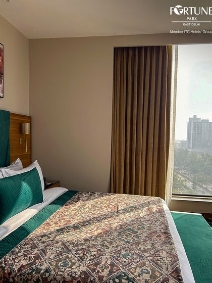 Enjoy the morning light in this corner of our deluxe room. The large window offers a pleasant view, making the room feel bright and airy.