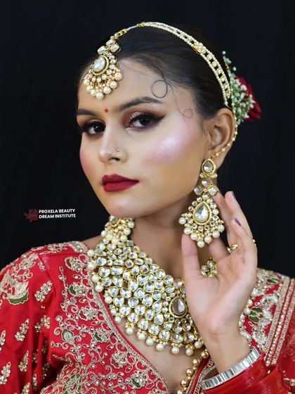 A three-quarter view showcasing the beautiful contouring and highlight that sculpts the face, along with the intricate details of the kundan jewelry.
