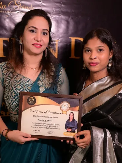 A student from our professional makeup and hair diploma course receiving her certificate of excellence.