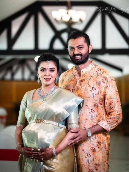 A beautiful portrait of the happy couple at their baby shower. Monica's makeup is classic and radiant, a perfect complement to her stunning silk saree and pregnancy glow.