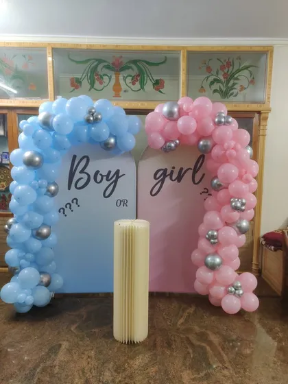 Planning a surprise? Our "Boy or Girl" gender reveal decorations create the perfect moment of anticipation. This setup features two distinct balloon arches in blue and pink, setting a fun and exciting stage for the big reveal.