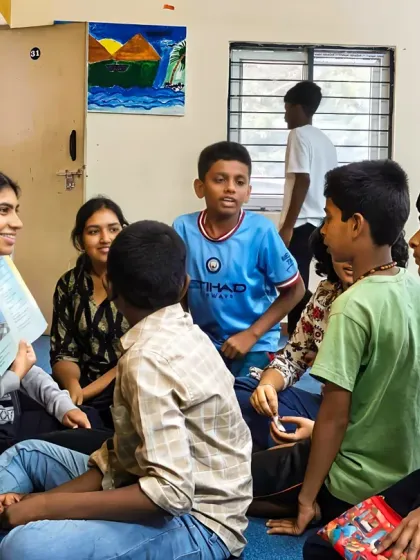 A volunteer sits on the floor with a group of boys, reading a story in an intimate and comfortable setting. We create a relaxed atmosphere where children feel safe to listen, ask questions, and engage with the narrative.