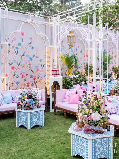 A cozy lounge from the 'Botanical Marrakesh' mehendi, featuring hand-painted walls and intricate bone inlay tables. This setup shows our dedication to creating immersive, detailed environments.