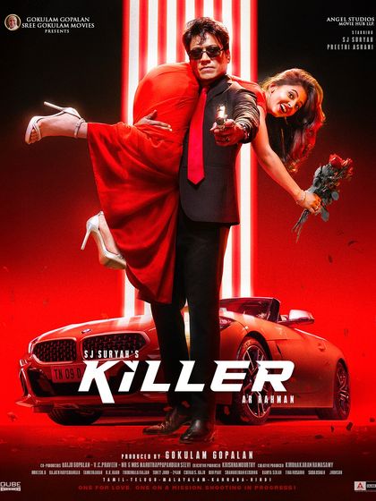 Another powerful poster from the movie *Killer*. The styling here focuses on a dramatic, high contrast look with a sharp black suit, a bold red tie, and a red dress for the co-star, all set against a vibrant red background.