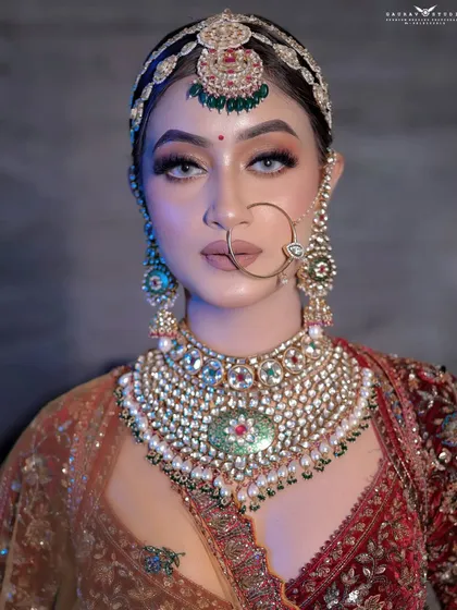 A direct, powerful portrait of the bride, her gaze fixed on the camera, showcasing her confidence.