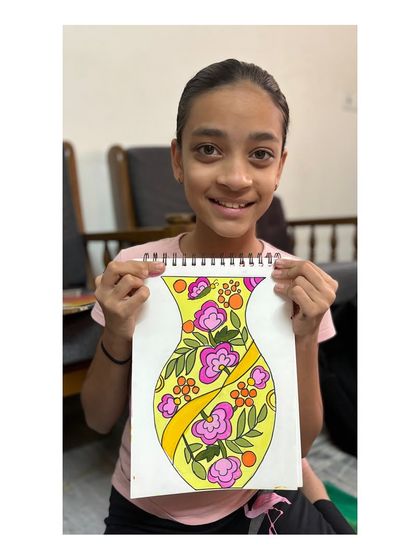 A student with her floral vase design for the intermediate grade exam. The bright, cheerful colours and flowing patterns make this a lovely piece.