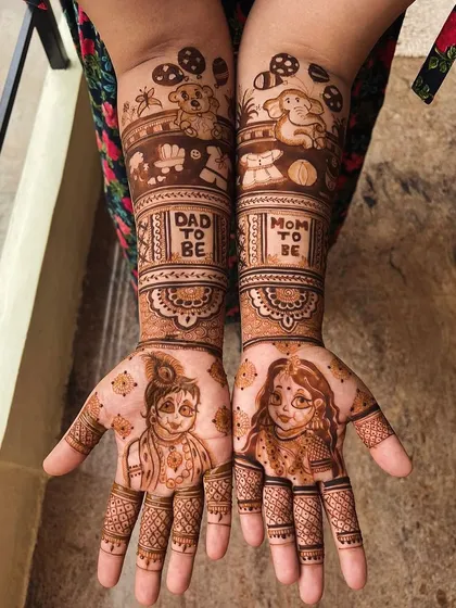 For those seeking divine blessings, I love creating designs with baby Krishna and baby Radha portraits. This intricate mehendi also celebrates the parents with "Mom to be" and "Dad to be" bands.