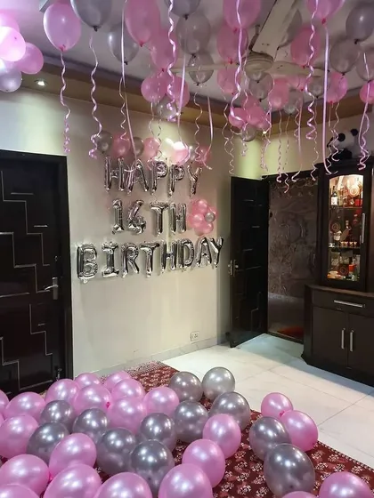 Here’s a fun and simple room decoration I did for a 14th birthday. The room is filled with pink and silver balloons on the floor and ceiling, with a 'Happy 14th Birthday' foil balloon banner as the main feature.