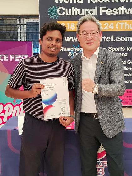 Our coach receiving a certificate at the Kukkiwon International event. Continuous learning is a core value for our coaching staff.