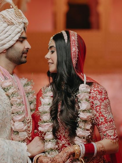 A beautiful moment between Nandika and Kunal during their wedding ceremony. Their expressions of love and admiration for each other are the central focus, telling a story without words.