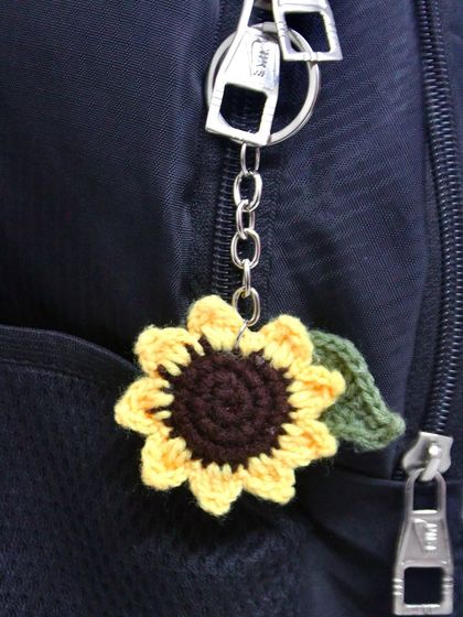Here is the sunflower keychain being used as a bag charm on a backpack. It's a great way to personalize your belongings.