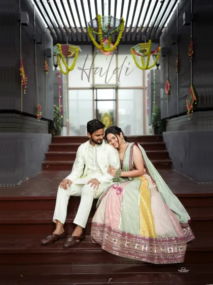 A sweet portrait of the couple during their Haldi ceremony. The bride rests her head on the groom's shoulder, a quiet moment amidst the festivities.