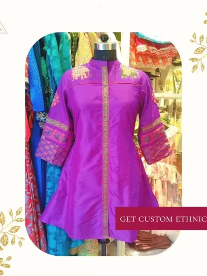 A custom ethnic kurta in a vibrant purple, featuring unique embroidery on the sleeves and shoulders.