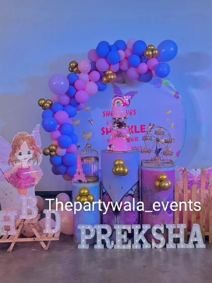 A sweet fairy tale theme with a blue and pink balloon arch. The setup includes a fairy cutout and light-up letters for the birthday girl's name.