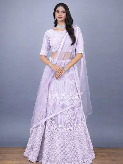 A full frontal view of the lavender lehenga, highlighting the geometric and floral resham work. The matching embroidered blouse and sheer dupatta create a harmonious and classy look.