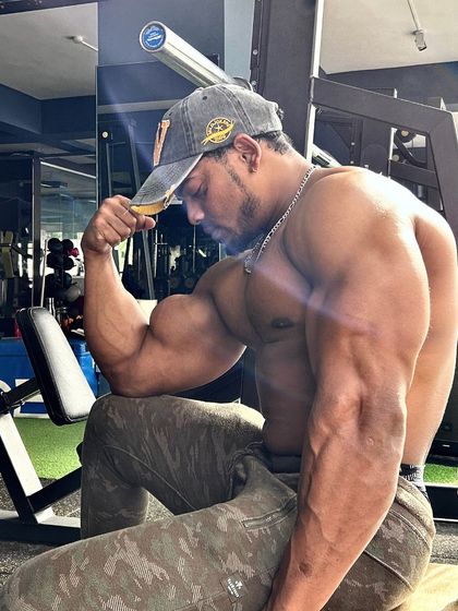 A classic bicep pose showcasing the size and definition that comes from dedicated arm training. Strength is built one rep at a time.
