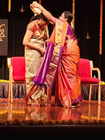 Blessing the young artist during her arangetram ceremony. It is a beautiful tradition to honor the student's hard work and dedication as she begins her journey as a performer.