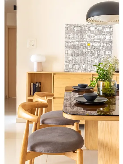 Another view of the dining area, with its curated art and simple, modern decor. The space is designed for quiet, mindful meals.