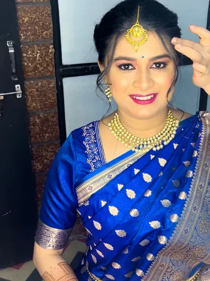 This client is glowing in a royal blue saree. I created a fresh, dewy makeup look with a bright pink lip to complement the outfit.