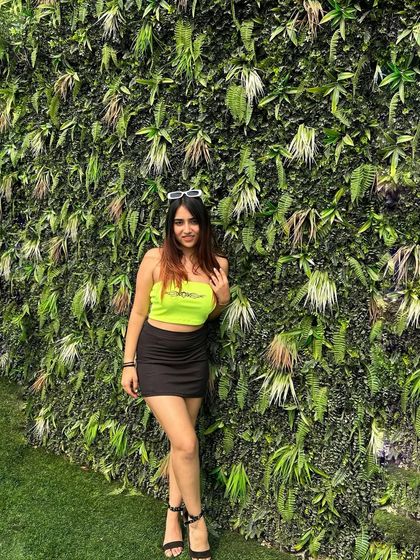 A final shot of the spicy neon look. This is a great example of a trendy and eye-catching party outfit.