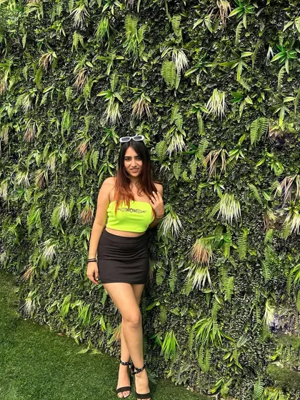 A final shot of the spicy neon look. This is a great example of a trendy and eye-catching party outfit.