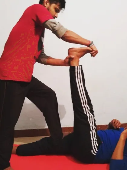 Assisted stretching is a key part of my recovery protocol. Here, I am helping a client with a hamstring stretch to increase flexibility, release tension, and prevent lower back issues.